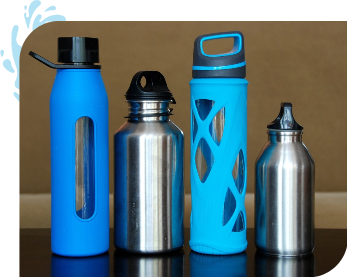 Four different water bottles are lined up on a table.